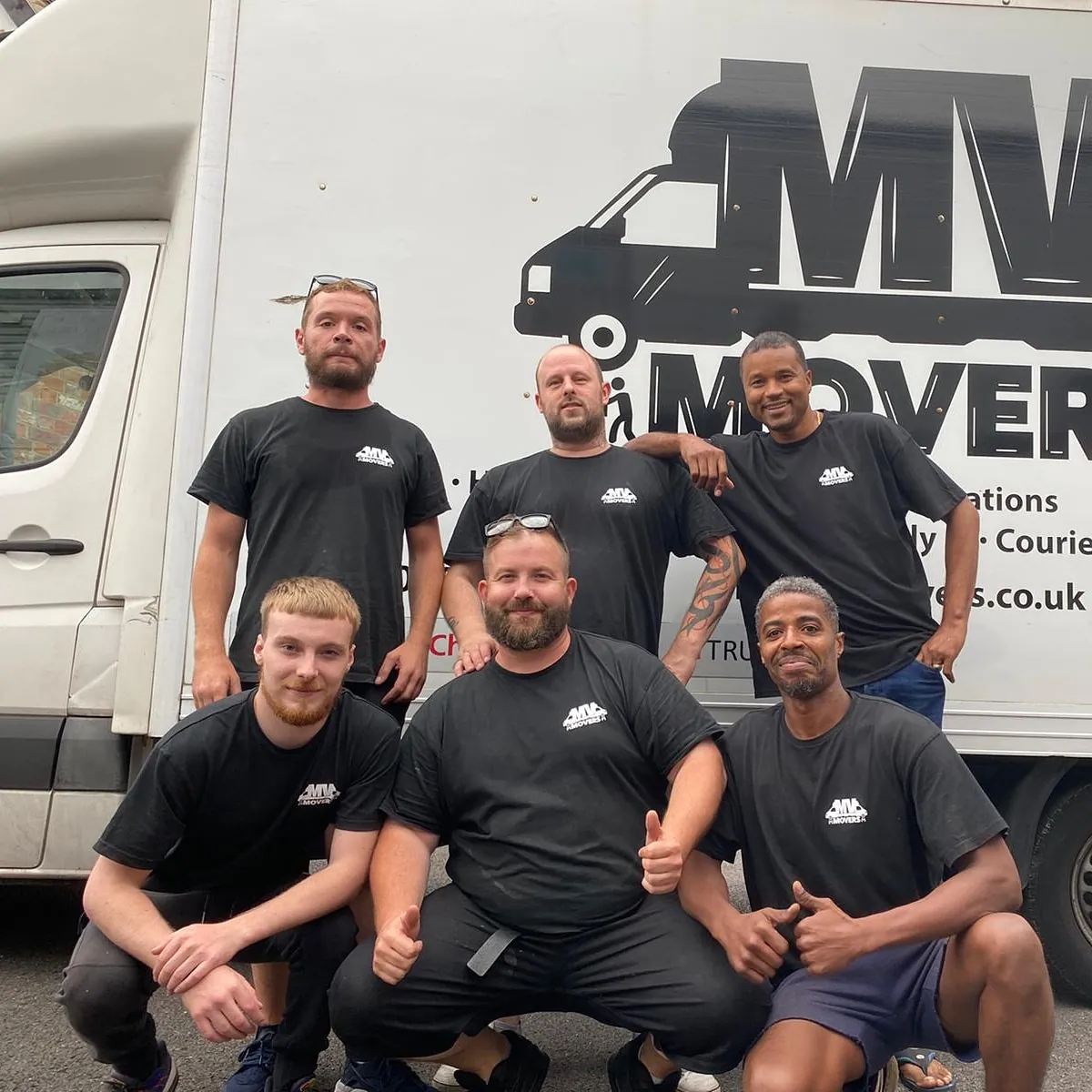 The MV Movers crew in front of a van